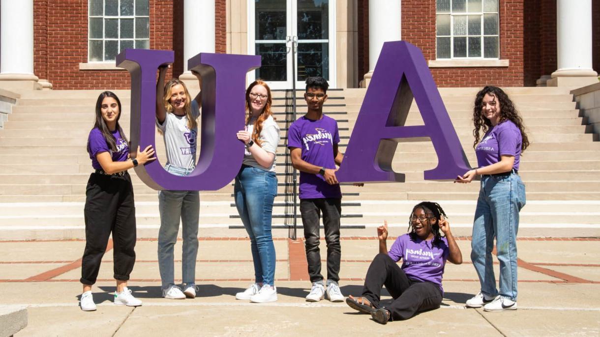 students holding large AU letters